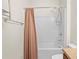 Bathroom featuring a shower over tub with curtain, a towel rack, and toilet at 758 Alpine Thistle Dr, Brooksville, FL 34604