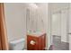Bathroom featuring vanity with mirror, toilet, and tan colored walls at 758 Alpine Thistle Dr, Brooksville, FL 34604