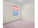 This carpeted bedroom features a window with a blind at 758 Alpine Thistle Dr, Brooksville, FL 34604