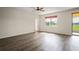 Spacious bedroom with hardwood floors, natural light, and access to the outdoor patio at 758 Alpine Thistle Dr, Brooksville, FL 34604
