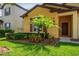 Charming home featuring a lush green lawn with well-maintained landscaping and a welcoming entryway at 758 Alpine Thistle Dr, Brooksville, FL 34604