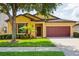 Charming single-story home featuring a well-manicured lawn, mature tree, and a two-car garage at 758 Alpine Thistle Dr, Brooksville, FL 34604