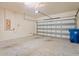 Spacious two-car garage with ample storage space, an automatic door opener, and epoxy flooring at 758 Alpine Thistle Dr, Brooksville, FL 34604