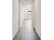 Hallway featuring hardwood flooring with white walls at 758 Alpine Thistle Dr, Brooksville, FL 34604