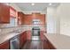 Kitchen with stainless steel appliances and tile backsplash, featuring a central island at 758 Alpine Thistle Dr, Brooksville, FL 34604