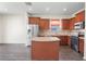 Bright kitchen featuring stainless steel appliances, an island, and warm wood cabinetry at 758 Alpine Thistle Dr, Brooksville, FL 34604