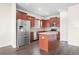 Well-lit kitchen featuring stainless steel appliances, central island, and dark wood cabinets at 758 Alpine Thistle Dr, Brooksville, FL 34604