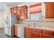 Kitchen area featuring stainless steel appliances, light countertops and warm cabinets at 758 Alpine Thistle Dr, Brooksville, FL 34604