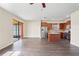 Open living room with dark wood floors, leading to a modern kitchen and screened patio at 758 Alpine Thistle Dr, Brooksville, FL 34604