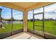 Enclosed patio featuring chairs and a view of the backyard at 758 Alpine Thistle Dr, Brooksville, FL 34604