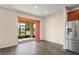 Sliding doors lead to a screened patio with backyard views and stainless steel refrigerator at 758 Alpine Thistle Dr, Brooksville, FL 34604