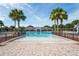 Beautiful community pool area with palm trees and ample seating for residents to enjoy at 758 Alpine Thistle Dr, Brooksville, FL 34604