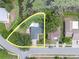 This aerial shot showcases a peaceful homesite bordered by greenery, pond, and well-defined street at 7701 Anaheim Ave, New Port Richey, FL 34655