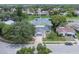 Aerial view of the property showcasing its proximity to a tranquil lake and lush greenery at 7701 Anaheim Ave, New Port Richey, FL 34655