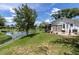 Backyard features green grass, lake view, and a patio area with room to unwind at 7701 Anaheim Ave, New Port Richey, FL 34655