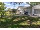 Backyard with a chain link fence, patio, and lush green grass provides a secure and private space at 7701 Anaheim Ave, New Port Richey, FL 34655