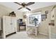 Charming bedroom features neutral walls, a ceiling fan, and bright window at 7701 Anaheim Ave, New Port Richey, FL 34655