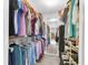 Spacious walk-in closet with ample hanging storage and shelving for organization at 7701 Anaheim Ave, New Port Richey, FL 34655