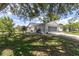 Charming single-Gathering home features a fenced yard with mature trees offering plenty of shade at 7701 Anaheim Ave, New Port Richey, FL 34655