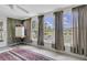 Enclosed Florida room with large windows overlooks a pond, creating a serene and inviting space at 7701 Anaheim Ave, New Port Richey, FL 34655
