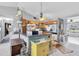 Bright kitchen with wood cabinets, functional appliances, a breakfast bar, and easy access to the adjacent living spaces at 7701 Anaheim Ave, New Port Richey, FL 34655