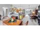 Open-concept kitchen with oak cabinets, a peninsula counter, and seamless transitions to the dining and living areas at 7701 Anaheim Ave, New Port Richey, FL 34655