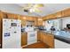 Bright kitchen showcases wood cabinets, a built-in sink, and plenty of natural light, offering an inviting space for cooking at 7701 Anaheim Ave, New Port Richey, FL 34655