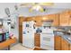 Well-lit kitchen featuring natural wood cabinetry, and ample space with modern appliances, creating a cozy and functional area at 7701 Anaheim Ave, New Port Richey, FL 34655