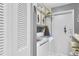 Organized laundry area with a washing machine, dryer, overhead cabinets, and storage at 7701 Anaheim Ave, New Port Richey, FL 34655