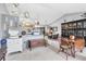 Inviting living area with vintage furniture flowing into the kitchen and dining areas to create a cohesive open living concept at 7701 Anaheim Ave, New Port Richey, FL 34655