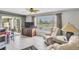 Comfortable living room with a large window offering scenic views of the tranquil lake at 7701 Anaheim Ave, New Port Richey, FL 34655