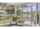 Enclosed patio boasts peaceful lake views and room to relax and unwind at 7701 Anaheim Ave, New Port Richey, FL 34655