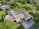 Overhead angle on roof, driveway, and landscaped lawn in quiet neighborhood at 8130 Bugle Ct # 3, Port Richey, FL 34668