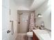 Bathroom featuring a shower with a seashell shower curtain, vanity with granite countertop and mirror at 8130 Bugle Ct # 3, Port Richey, FL 34668