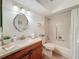 Well-maintained bathroom with a shower-tub combo, single vanity, and neutral finishes at 8130 Bugle Ct # 3, Port Richey, FL 34668