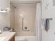 Cozy bathroom featuring a shower-tub combo with handrails and bright overhead lighting at 8130 Bugle Ct # 3, Port Richey, FL 34668