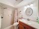 Bright bathroom with shower, vanity, sink, mirror, and seashell-themed decor for a coastal feel at 8130 Bugle Ct # 3, Port Richey, FL 34668
