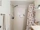 Bathroom with shower and vanity featuring granite counters and seashell-themed decor at 8130 Bugle Ct # 3, Port Richey, FL 34668
