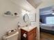 Cozy bathroom featuring a decorative mirror, updated vanity and lighting at 8130 Bugle Ct # 3, Port Richey, FL 34668