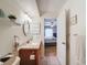 Bathroom with a shower, vanity with mirror, and doorway to the bedroom with a comfortable bed at 8130 Bugle Ct # 3, Port Richey, FL 34668