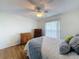 Bright bedroom featuring a ceiling fan, wood-look floor, and updated decor at 8130 Bugle Ct # 3, Port Richey, FL 34668