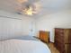 Comfortable bedroom featuring a ceiling fan, wood-look floors and neutral paint at 8130 Bugle Ct # 3, Port Richey, FL 34668