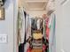 Walk-in closet with ample hanging and storage space, well-organized at 8130 Bugle Ct # 3, Port Richey, FL 34668