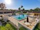 Sunny community pool area featuring lounge chairs and well manicured greenery at 8130 Bugle Ct # 3, Port Richey, FL 34668