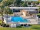 Aerial view of community pool, cabana, landscaping, and surrounding buildings at 8130 Bugle Ct # 3, Port Richey, FL 34668