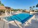 Beautiful community pool and cabana with plentiful seating and landscaping at 8130 Bugle Ct # 3, Port Richey, FL 34668