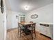 Dining room with wood table and chairs, white wainscoting, and hardwood floors at 8130 Bugle Ct # 3, Port Richey, FL 34668