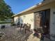 Front door leads to cozy outdoor seating area with beautiful pavers and manicured landscaping at 8130 Bugle Ct # 3, Port Richey, FL 34668