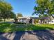 Charming single-story home with a well-manicured lawn and beautiful landscaping at 8130 Bugle Ct # 3, Port Richey, FL 34668