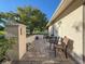 Welcoming patio space with outdoor seating and beautifully textured paving stones, accented by potted plants at 8130 Bugle Ct # 3, Port Richey, FL 34668